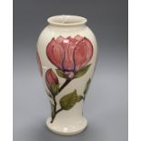 A Moorcroft magnolia pattern baluster vase, with pink flowers on a cream ground, height 31cm