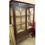 An Edwardian mahogany display cabinet, W.110cm D.38cm H.175cm Condition: The moulding on the lower