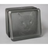 A modern Lalique smoky green tinted glass box, decorated with a cat's head, 11 x 9.5cm, height