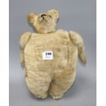 An early 20th century gold plush teddy bear hand warmer, with boot button eyes, length 40cm