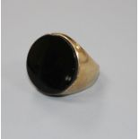 A yellow metal (stamped 9ct) and black onyx set circular signet ring, size L, gross weight 9