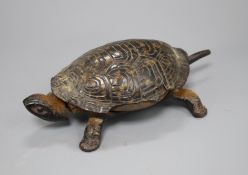 A Victorian cast iron and simulated tortoiseshell table bell, modelled as a tortoise, length 17cm