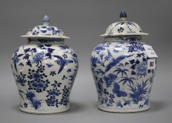 A pair of 19th century Chinese blue and white vases and covers, decorated with birds and flowers,