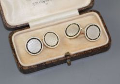 A pair of yellow metal (stamped TM 18ct), mother of pearl and enamel disc cufflinks, gross weight 10