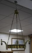 An Edwardian brass light fitting, made for electricity, lacking shade, drop 94cm, diameter 56cm