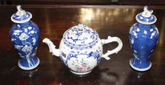 An 18th century Chinese export teapot, with famille rose floral decoration, height 15cm and a pair