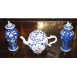 An 18th century Chinese export teapot, with famille rose floral decoration, height 15cm and a pair