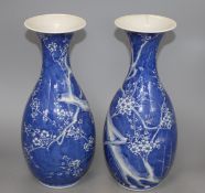 A pair of Japanese blue and white baluster vases, decorated with prunus trees, six character mark,