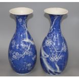 A pair of Japanese blue and white baluster vases, decorated with prunus trees, six character mark,