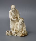 A Japanese Meiji period ivory okimono carved with a doctor treating a man's ear, signed, height 12cm