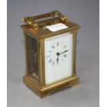 An Edwardian brass carriage timepiece with enamelled Roman dial, height 12.5cm Condition: Good clean