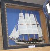 A painted wood ship model, in display frame, overall 42 x 52cm Condition: Sails looks a little faded