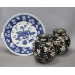 A pair of Chinese famille noire ginger jars and covers, decorated with prunus, height 20cm, and a