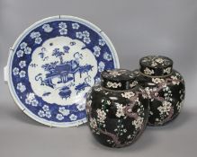 A pair of Chinese famille noire ginger jars and covers, decorated with prunus, height 20cm, and a