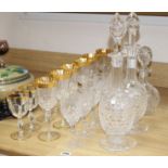 A pair of Stuart? cut glass decanters and stoppers, another decanter, a set of eight vineous