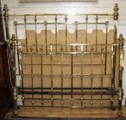 An Edwardian brass double bedstead, with ring turned finials and squared bars, W.156cm H.