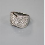 A modern 18ct white gold and pave set diamond 'crossover' dress ring, with a total diamond weight of