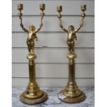 A pair of Italian gilt metal candelabra, with putto stems and marble bases, height 51cm Condition: