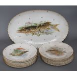 A Limoges thirteen piece porcelain fish service, printed with pike and other freshwater fish