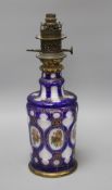 A Bohemian blue overlaid glass oil lamp base, painted with flowers, overall height 42.5cm Condition: