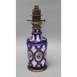 A Bohemian blue overlaid glass oil lamp base, painted with flowers, overall height 42.5cm Condition: