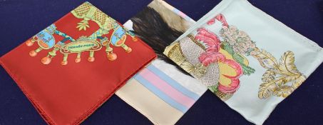 Three Hermes silk scarves, with one original Hermes orange card box Condition:- Carousel 84 x 84cm -