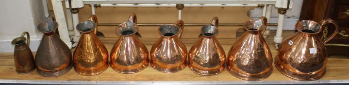 A collection of eight assorted copper flagons, largest 33cm, most of these are old Victorian