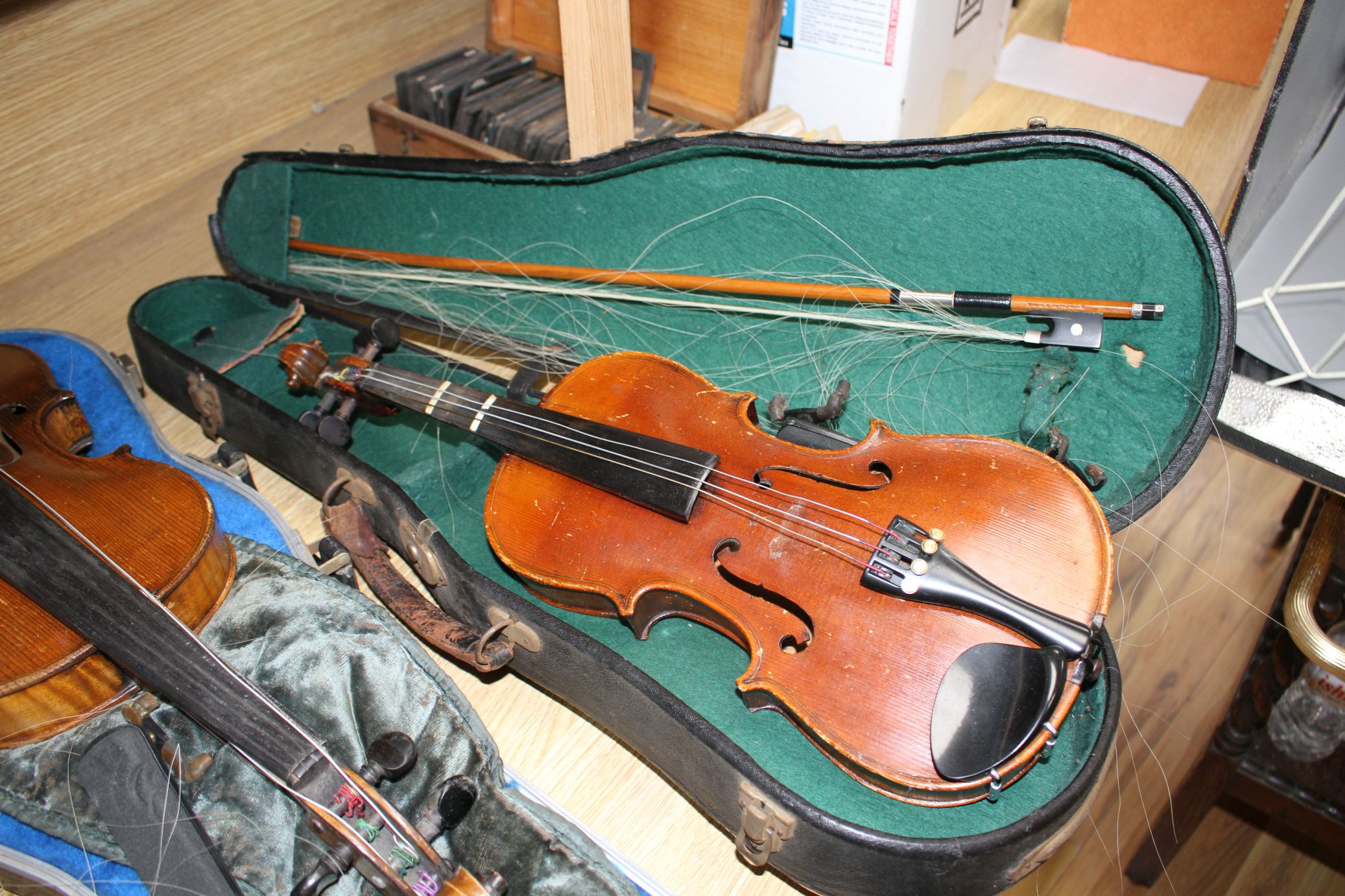 A violin with two piece back and bow, and a child's violin with bow, both with cases Condition:- - Image 40 of 44