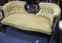 An Edwardian carved and ebonised three-seater settee, with button back and original ceramics