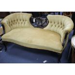An Edwardian carved and ebonised three-seater settee, with button back and original ceramics