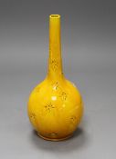 A Burmantofts yellow glazed vase, with impressed stylised floral decoration, monogrammed and