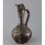 A Turkish Cannakale pottery ewer, 19th century, applied with medallions and scroll decoration and