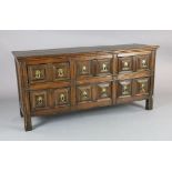 A 17th century style oak dresser base, fitted six geometric moulded drawers with drop handles, on