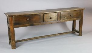 A late 18th century style oak dresser base, fitted three long drawers, on stile feet with H