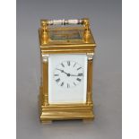 A 20th century silvered and gilt quarter repeating carriage clock, with enamelled Roman dial,