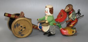 Three old tinplate clockwork toys and a tinplate cannon Condition:- drumming clown, height 11cm,