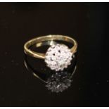 A modern 9ct gold and diamond cluster ring, size O, gross weight 2.2 grams. Condition: Three of