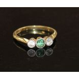 An 18ct and plat, green tourmaline and diamond set three stone ring, size M, gross weight 2.3 grams.