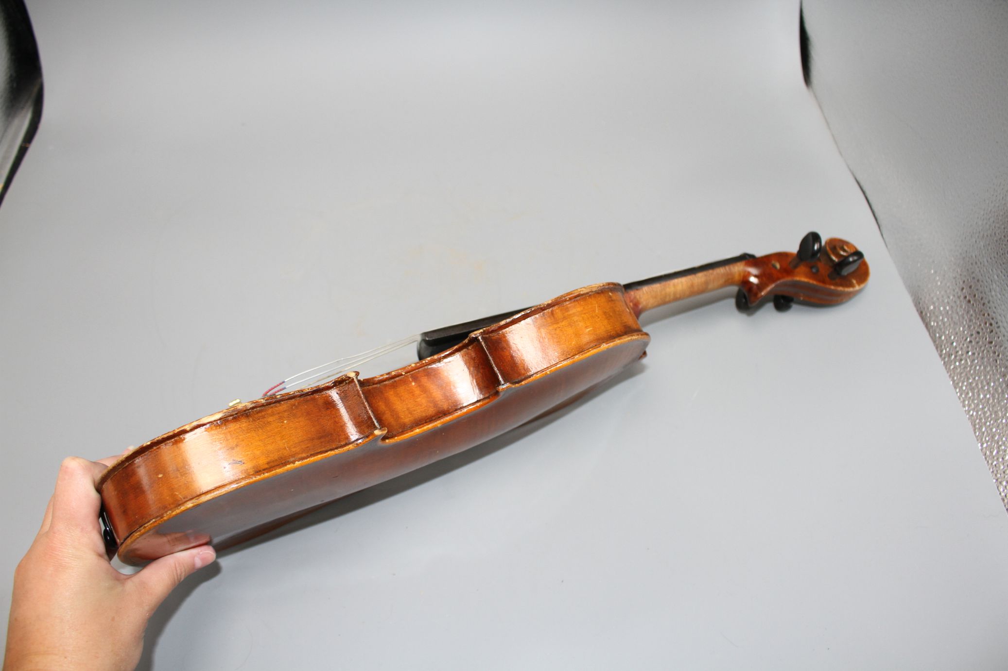 A violin with two piece back and bow, and a child's violin with bow, both with cases Condition:- - Image 25 of 44