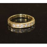 A modern 18ct gold and seven stone diamond set half eternity ring, size R, gross weight 4.9 grams.