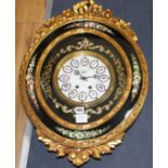 An ornate gold and floral painted oval wall clock, the dial signed Nacar, W.48cm H.68cm Condition: