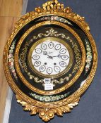 An ornate gold and floral painted oval wall clock, the dial signed Nacar, W.48cm H.68cm Condition: