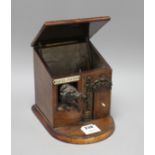 An early 20th century French novelty tobacco box, modelled as a porter's lodge, with a bronze dog in