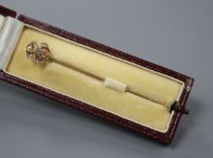 An early 20th century French yellow metal (poincon marks for 18ct), ruby and diamond stick pin, with