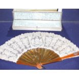 A Maison Patte-Hannot boxed lacework fan, with simulated amber sticks, inset with a rose diamond set