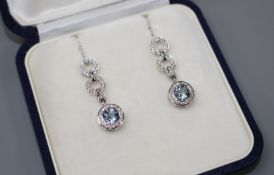 A modern pair of 18ct white gold, aquamarine and diamond set drop earrings, drop 29mm, gross