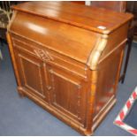 An Edwardian pine washstand, the rising top opening to reveal marble lined interior and mirror, over