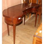 A mahogany kidney shaped dressing table, W.120cm D.50cm H.77cm Condition: The top has lost a piece