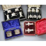 Four cased sets of silver, including pair of napkin rings, six grapefruit spoons, mounted