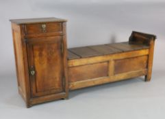 An early 19th century French oak box seat settle, with frieze drawer and cupboard flanking a box